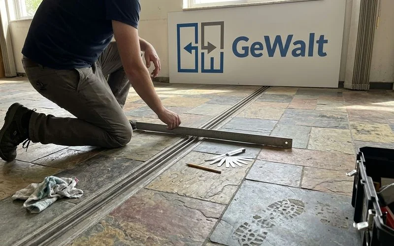 Technician measuring a worn floor track