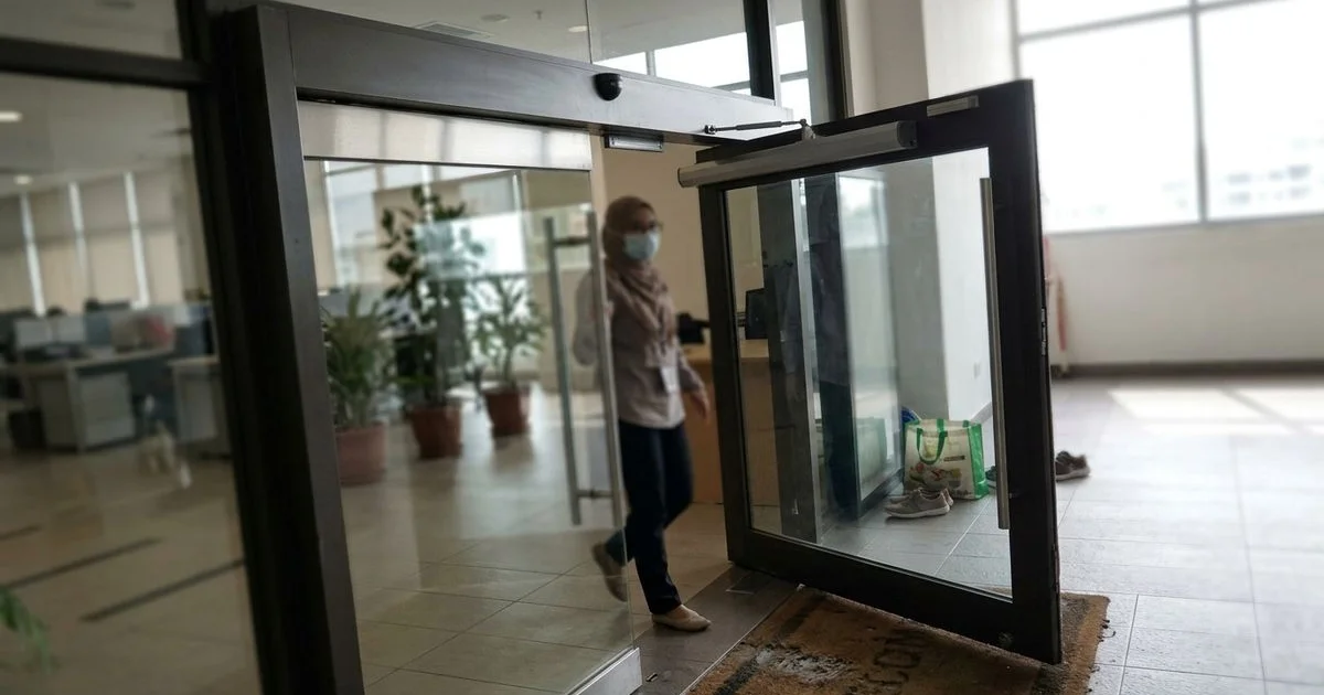 Automatic swing door opening at a Malaysian office lobby