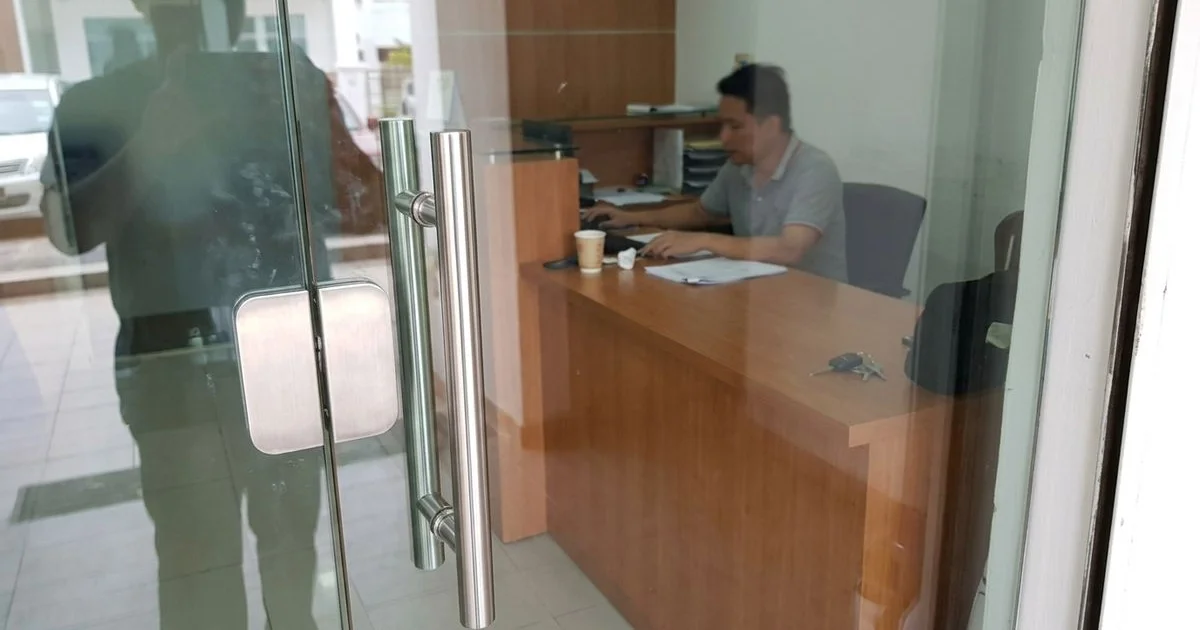 Frameless tempered glass door at a Malaysian office entrance