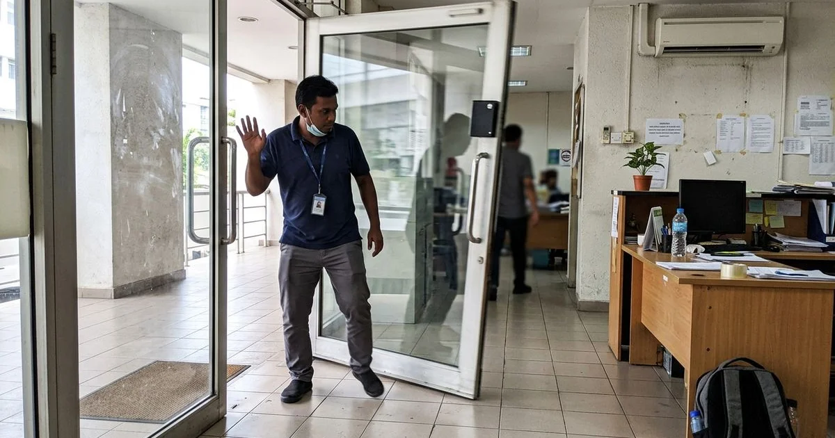 Heavy glass door swinging shut hard at an office entrance