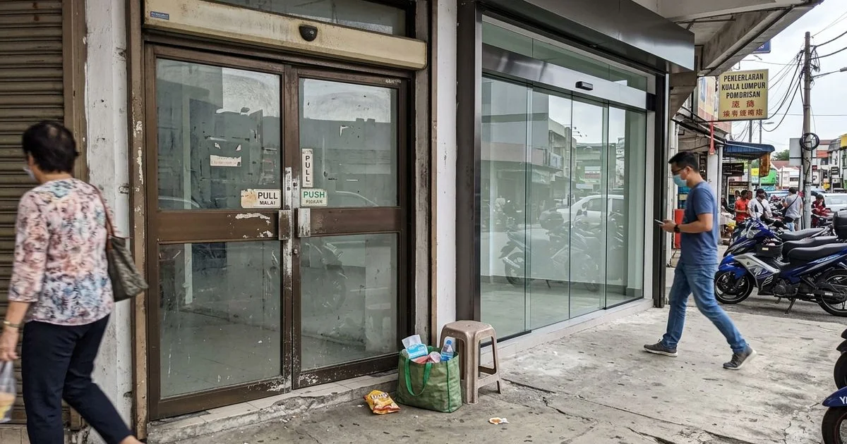 Old worn automatic door beside a newly installed system