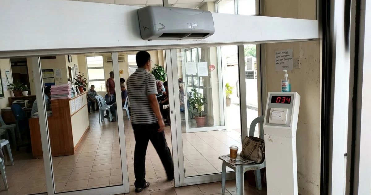 Sensor housing above an automatic sliding door in a Malaysian clinic