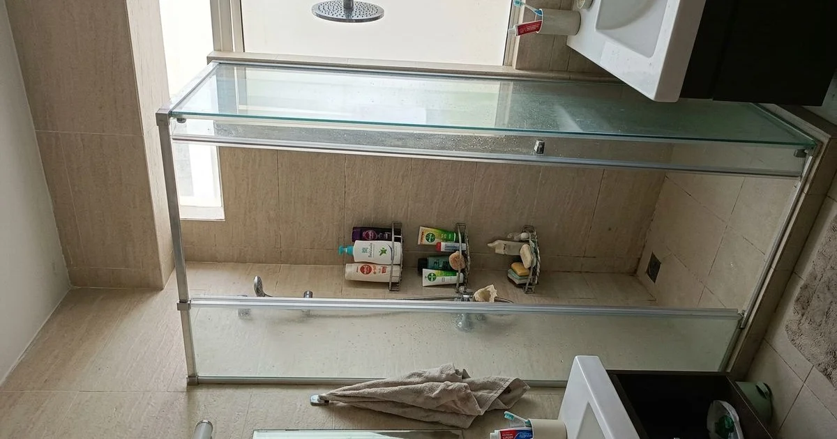 Sliding glass shower door in a modern Malaysian bathroom