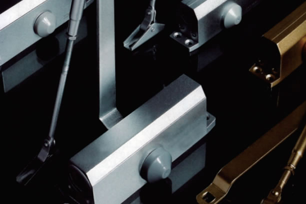 Automatic door closer mounted at the head of a door in Malaysia